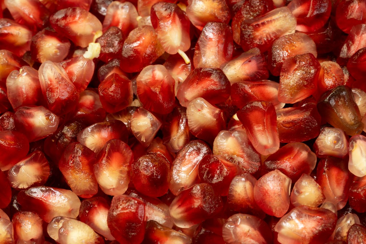 services-01 Vibrant red pomegranate seeds in a close-up shot.