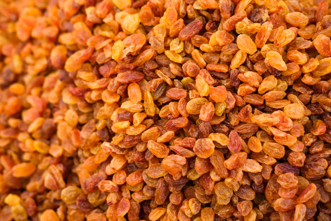 why-choose-us-02 Top view of a heap of dried golden raisins, perfect for culinary and healthy eating visuals.