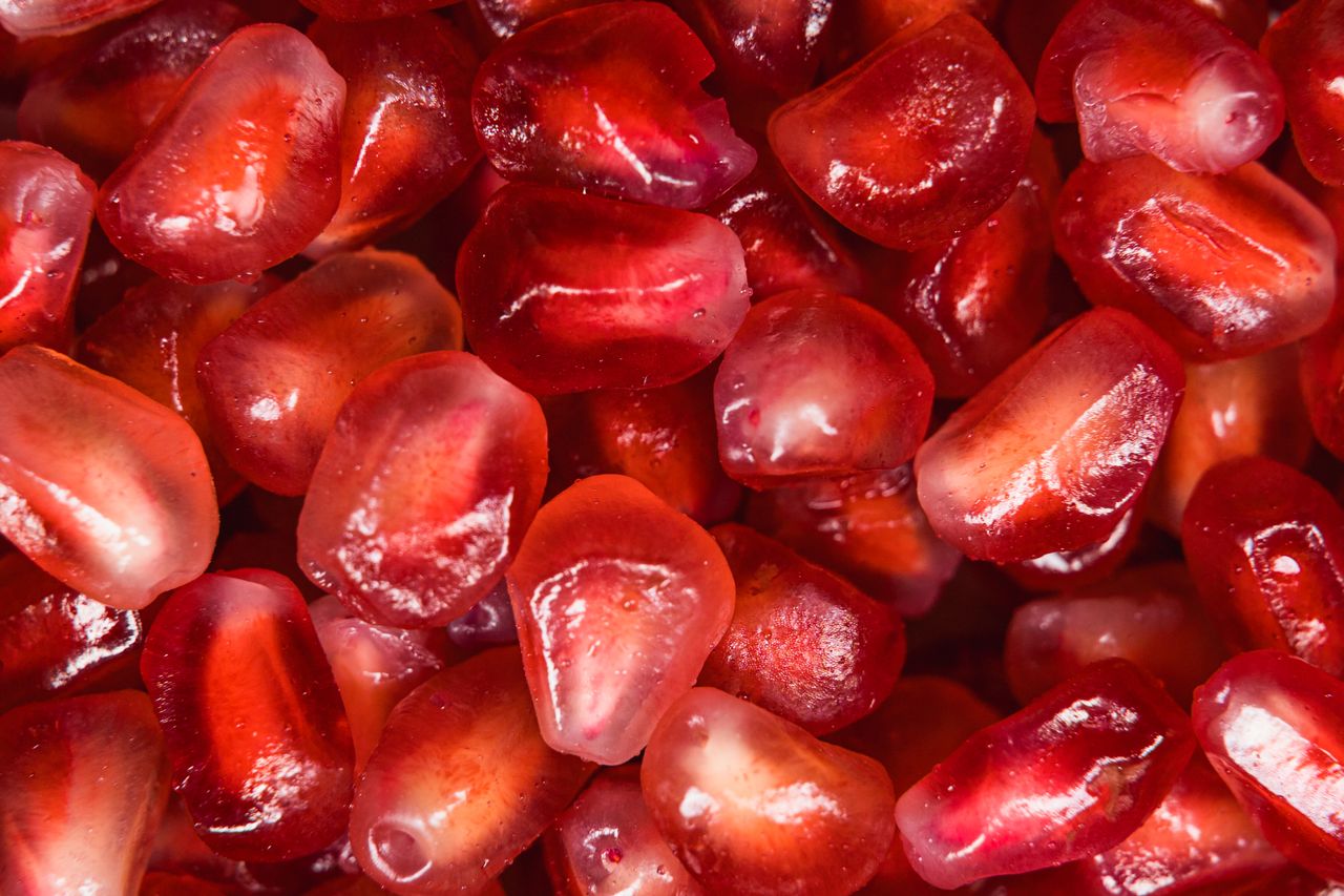 Macro shot of fresh, juicy pomegranate seeds showcasing their rich red color and texture.